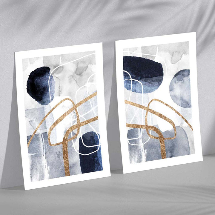 Sett med 2 kunsttrykk i abstrakt rammedesign i blått og gull