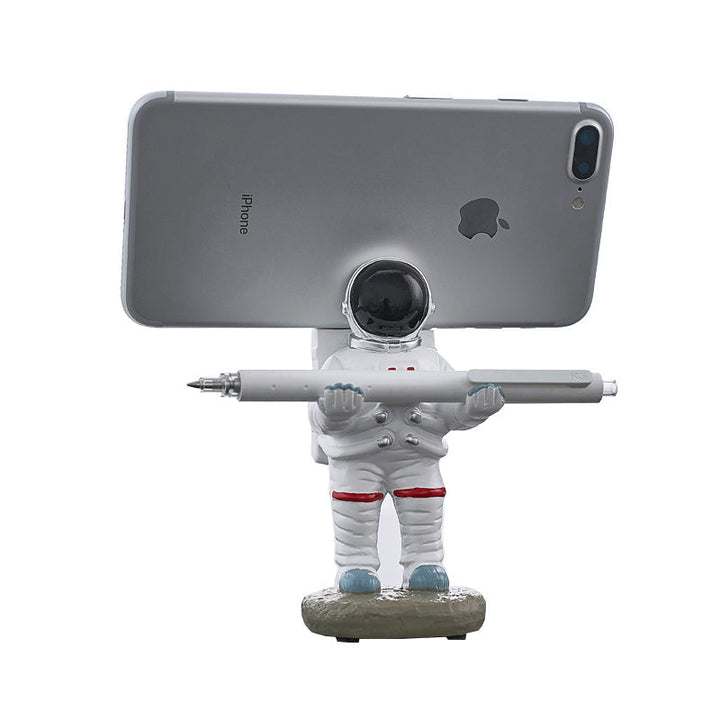 Støtte for mobiltelefon eller penn i astronautdekorasjoner | Skanto