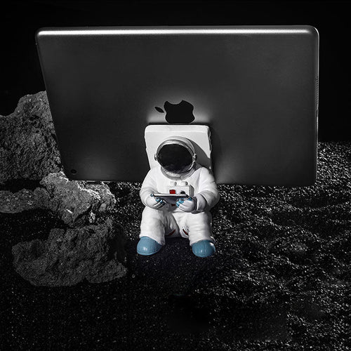 Støtte for mobiltelefon eller penn i astronautdekorasjoner | Skanto