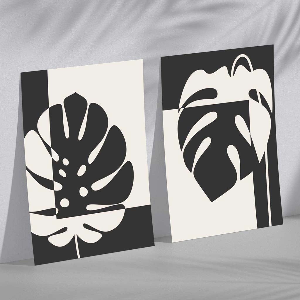 Sett med 2 innrammede kunsttrykk med Monstera-motiver i svart og beige