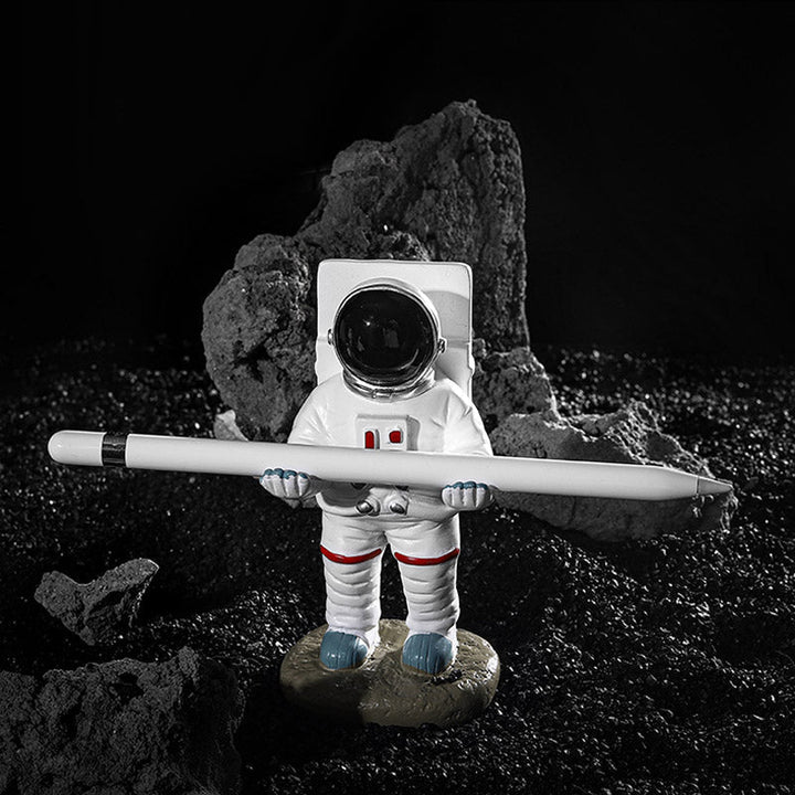 Støtte for mobiltelefon eller penn i astronautdekorasjoner | Skanto