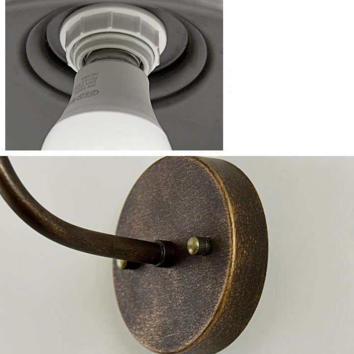 Rund, lokkformet vegglampe med buet jernskjerm og enkeltflammedesign for terrassen