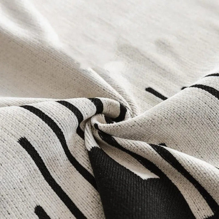 Skanto | Elegant svart og hvitt sofa dekke beskytter