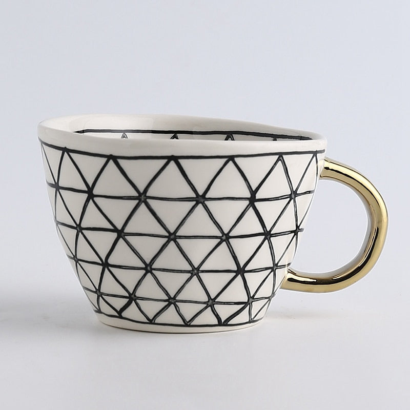 Skanto | Cup med abstrakt geometrisk mønster og gullhåndtak