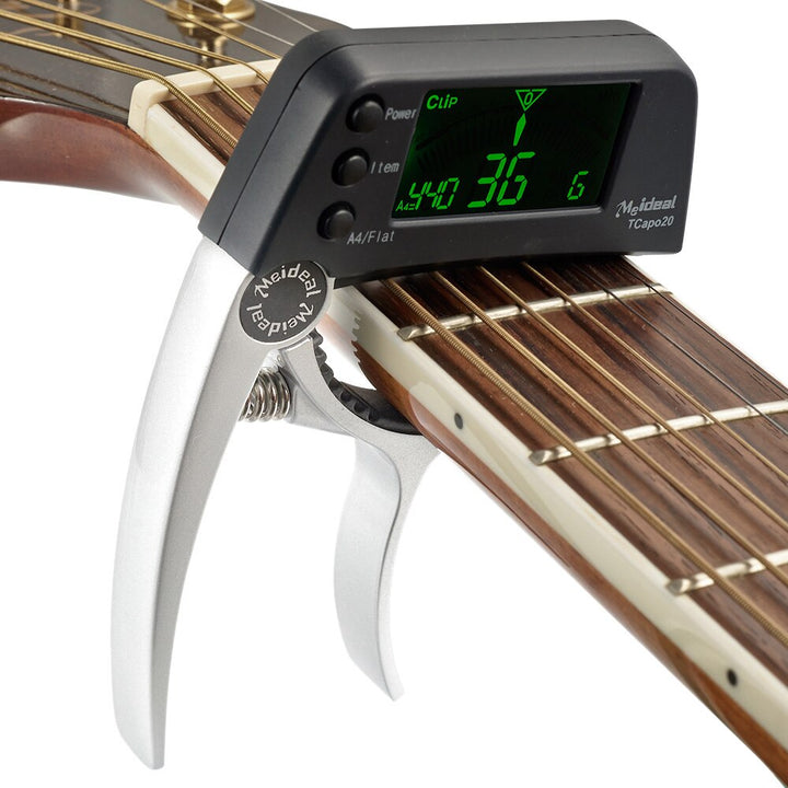 Capo & Tuner "TuneGrip" – 2-i-1 gitar tilbehør med LCD-skjerm | Skanto