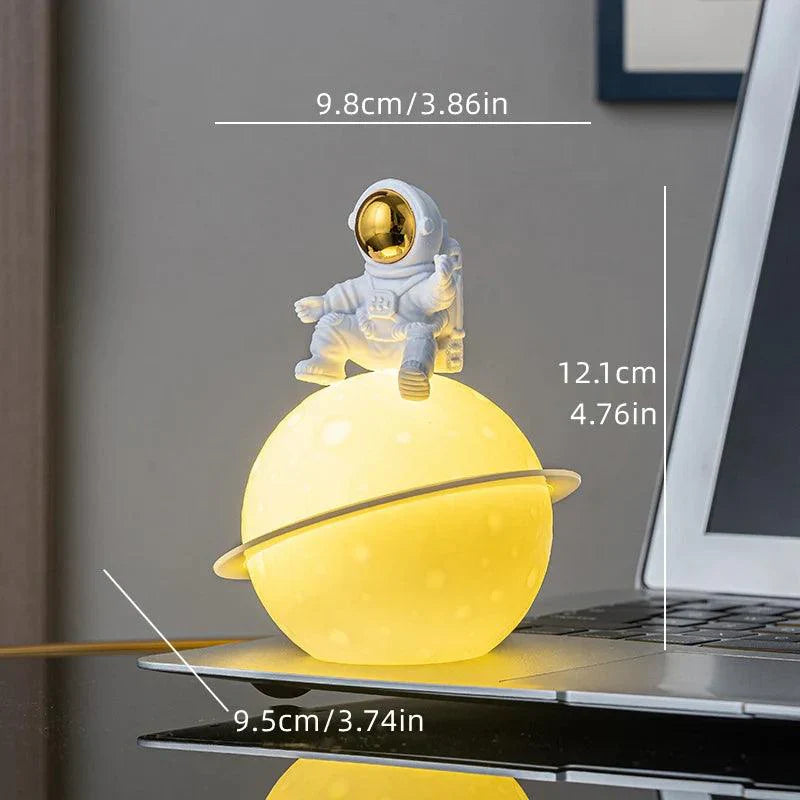 Skanto | AstroLume Astronaut Skulptur med Planet Nattlys | Moderne Dekorativt Høydepunkt | Miljøvennlig PVC & ABS | 9.8 x 12.1 cm