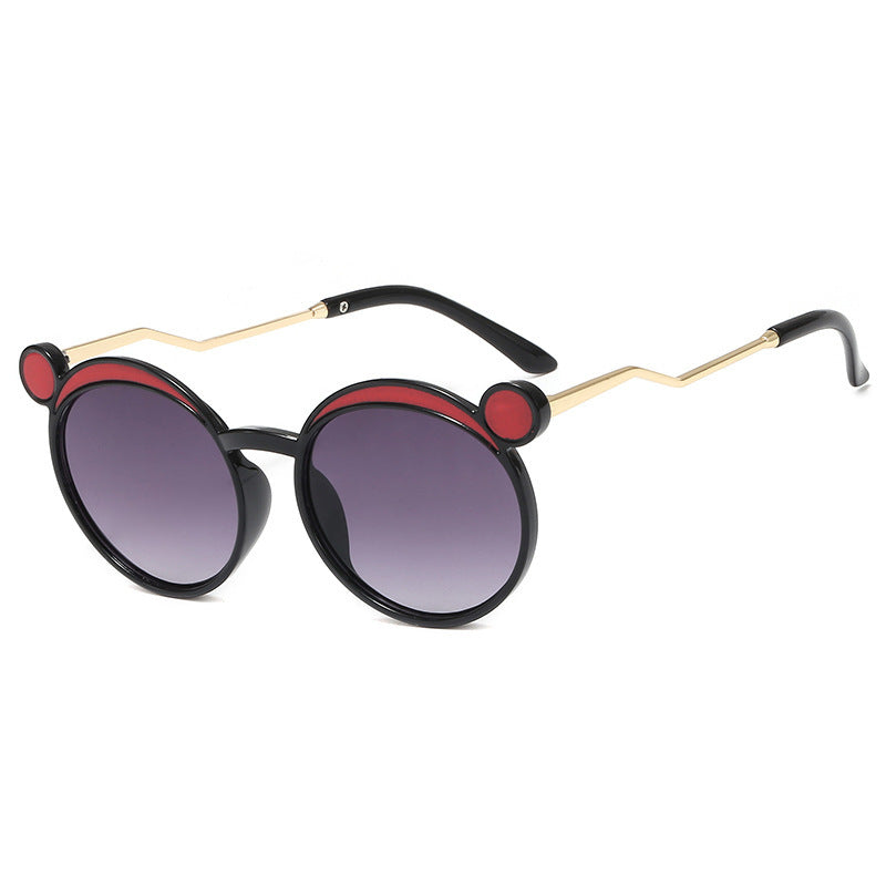 Dame Fashion-runde solbrille med innovativ ramme og fargede linser Skanto