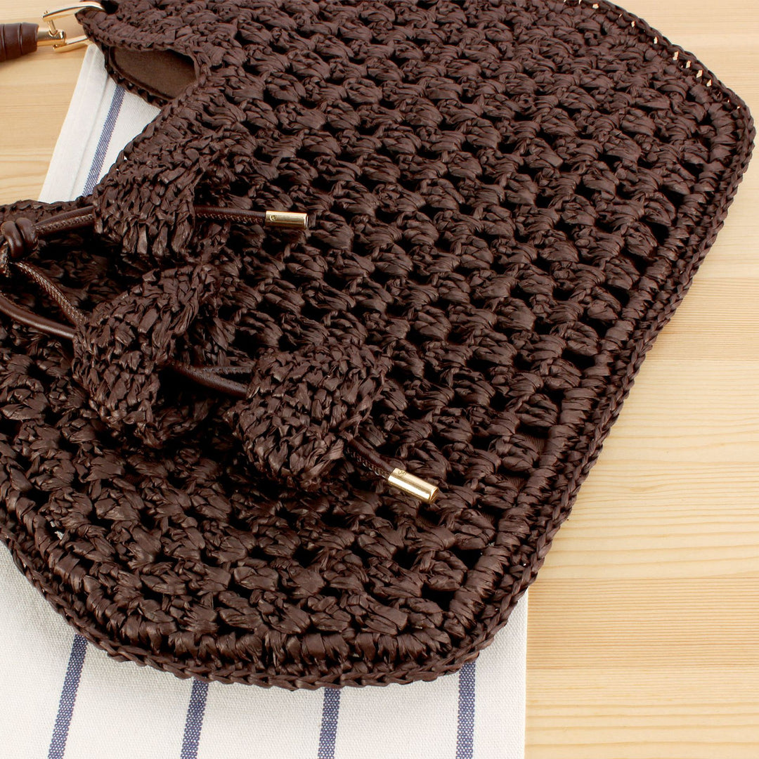 Handbag made of artisanal natural material with unique tassel pendant Skanto