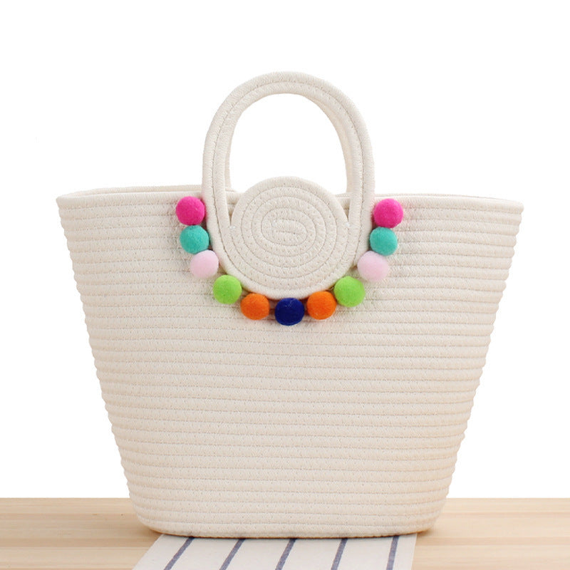 Modern handbag with playful pom-pom embellishments Skanto