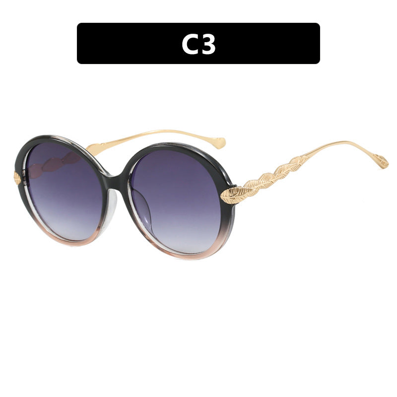 Dame stor rund solbrille med dekorative metalakser Skanto