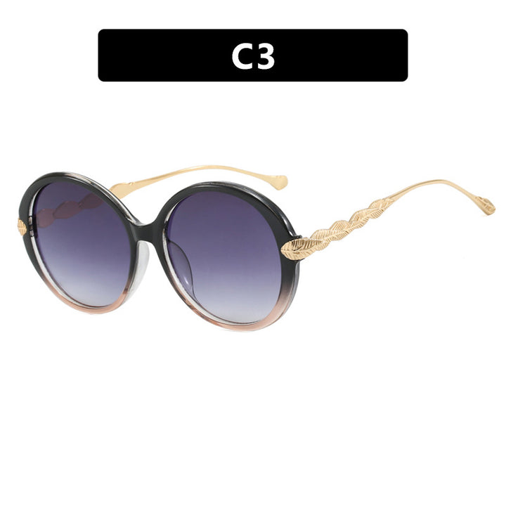 Dame stor rund solbrille med dekorative metalakser Skanto