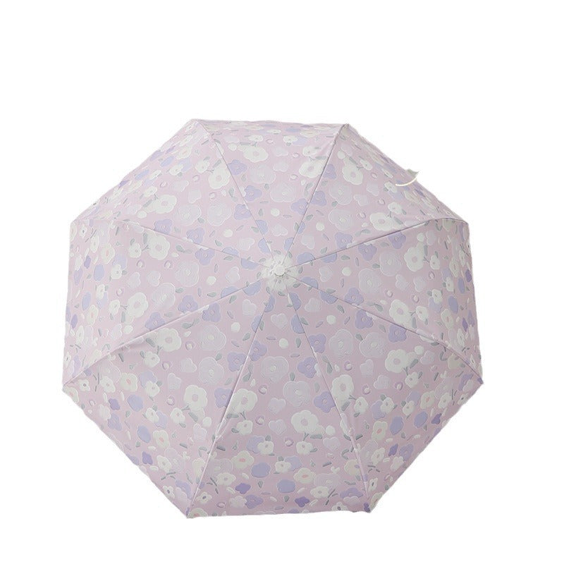 Dame sammenleggbar paraply med stilfullt blomstedesign Skanto