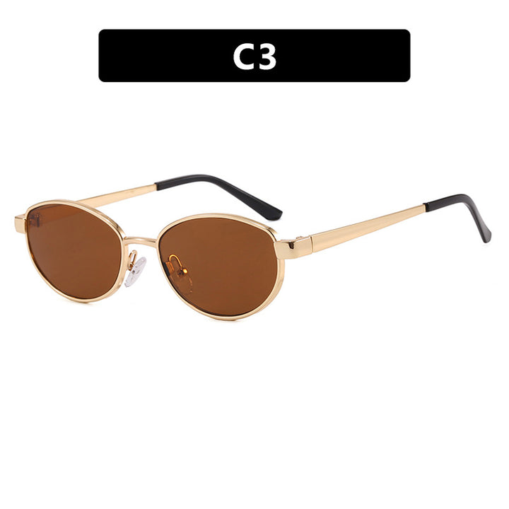 Dame moteriktig solbrille i elegant oval design med ramme i høykvalitets metall Skanto