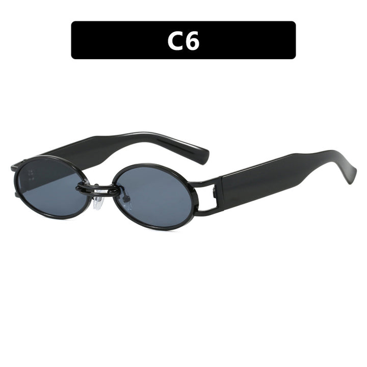 Dame ovalformet solbrille med gullige accenter og stilig ramme Skanto