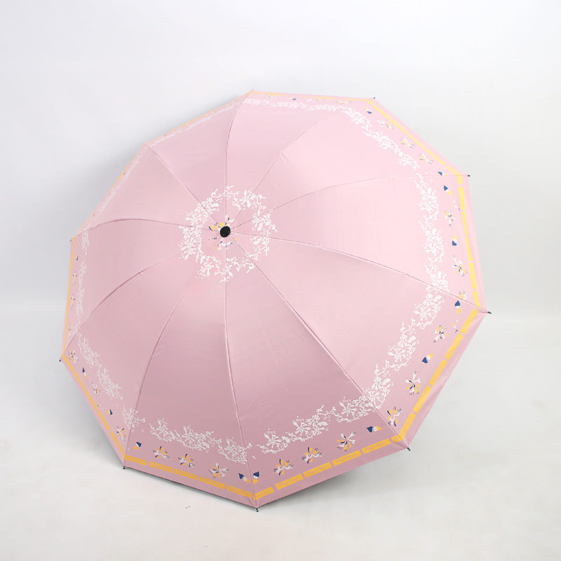 Kvinnens elegante sammenleggbare paraply med blomsterdesign Skanto