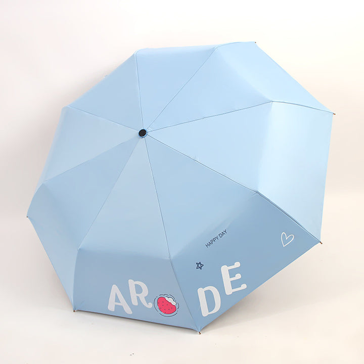 Kvinnens sammenleggbare paraply med lystig design Skanto