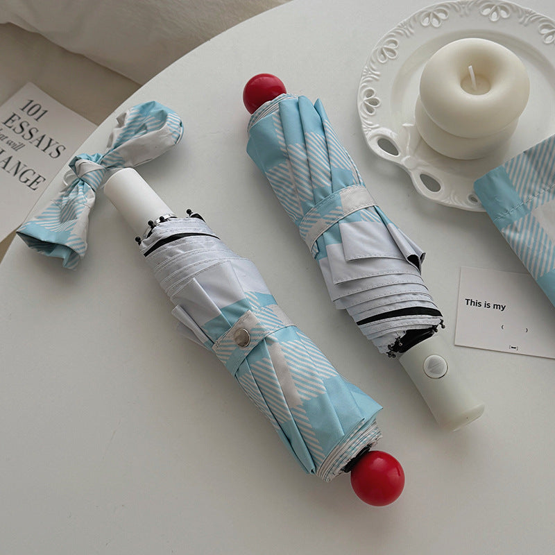 Dame sammenleggbart paraply med spesiell design Skanto
