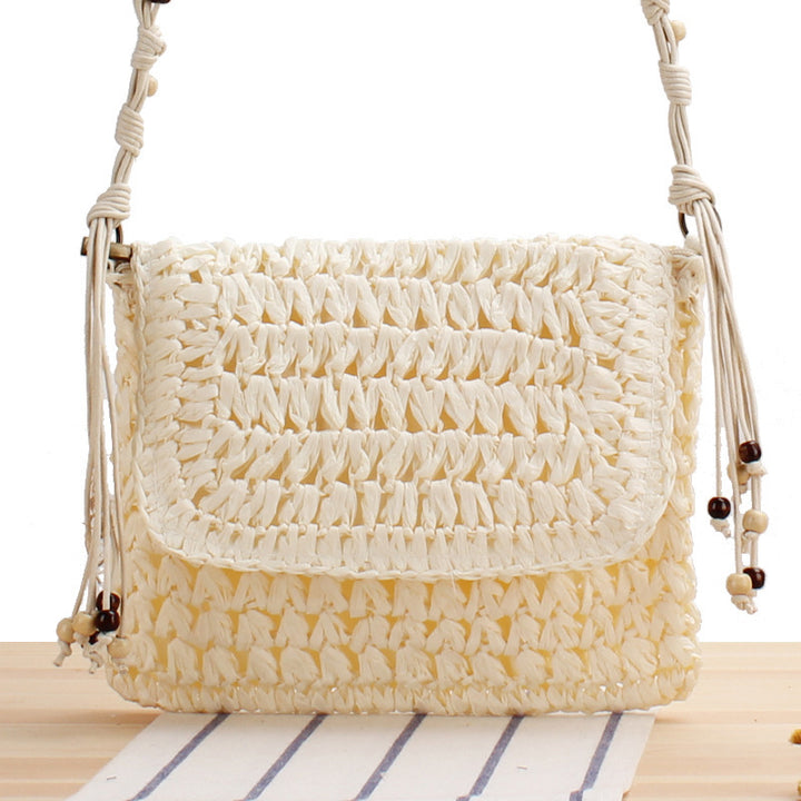 Woven natural material handbag with playful fringes Skanto