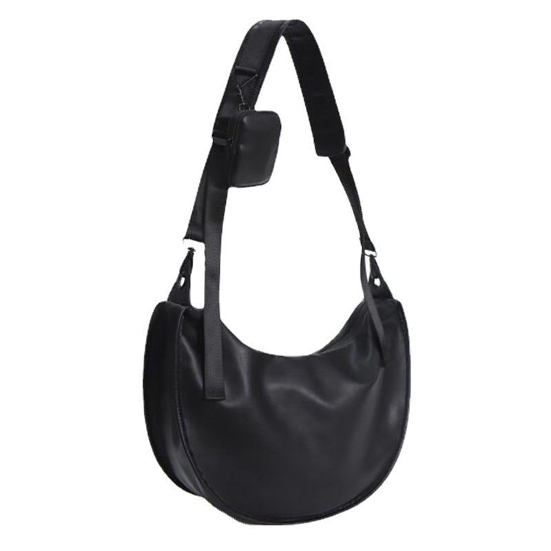 Elegant skulderveske i buet form Skanto