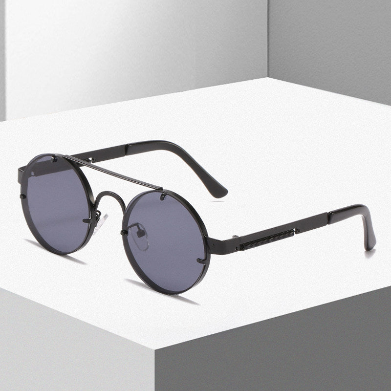Dame rund designer solbrille med innovativ metallramme og beskyttende linser Skanto