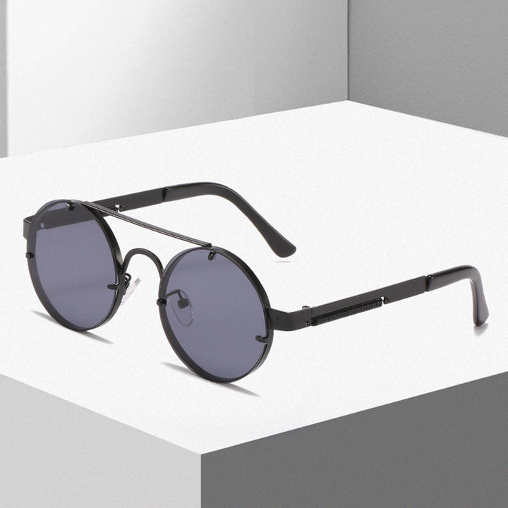Dame rund designer solbrille med innovativ metallramme og beskyttende linser Skanto