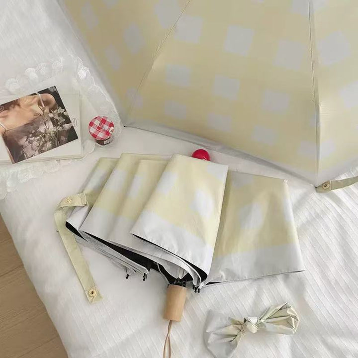 Dame sammenleggbart paraply med spesiell design Skanto