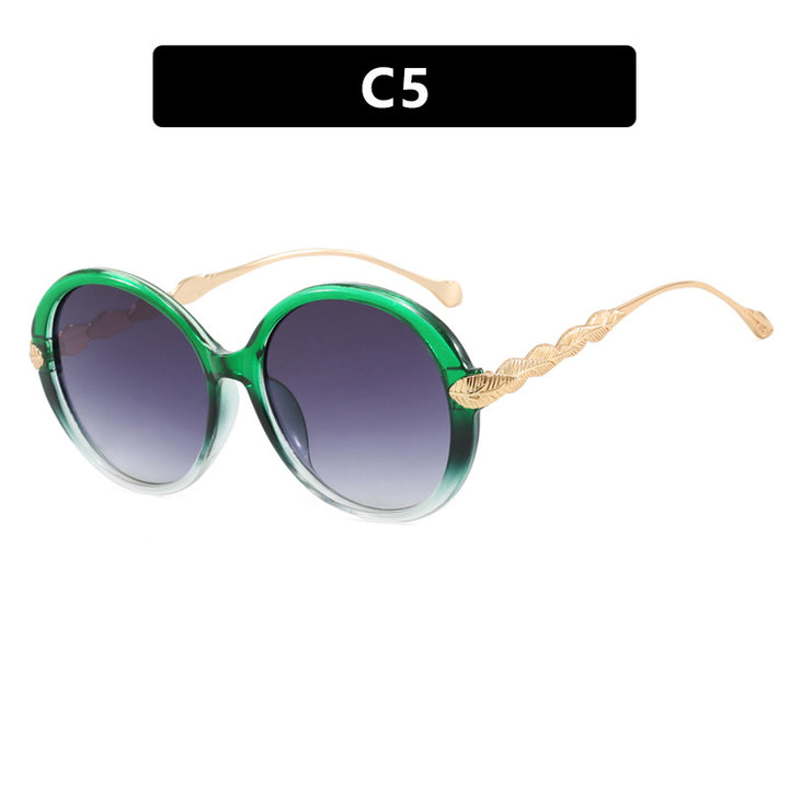Dame stor rund solbrille med dekorative metalakser Skanto