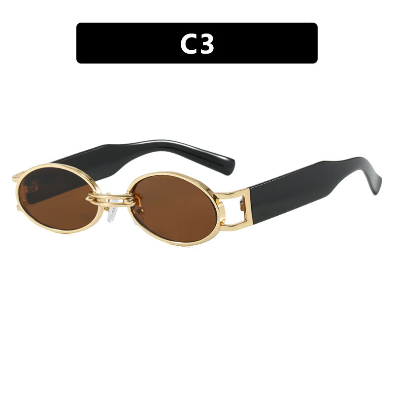Dame ovalformet solbrille med gullige accenter og stilig ramme Skanto