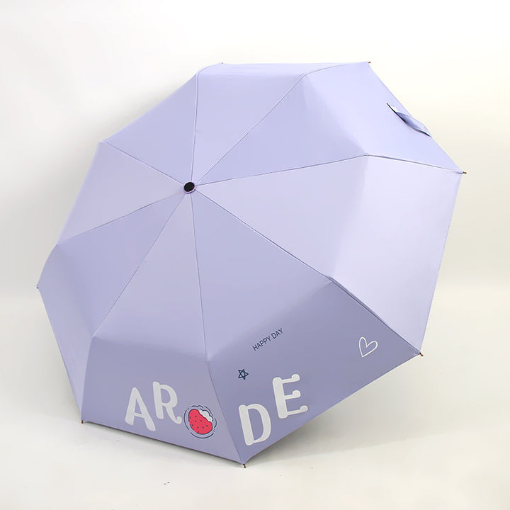 Kvinnens sammenleggbare paraply med lystig design Skanto