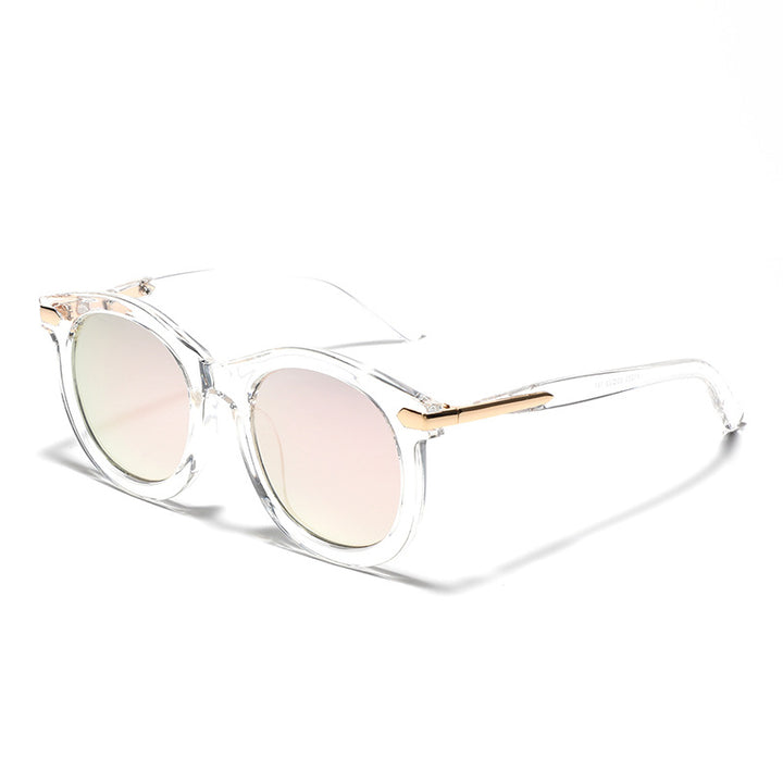 Dame moteriktig solbrille med gjennomsiktig ramme og gull accenter Skanto