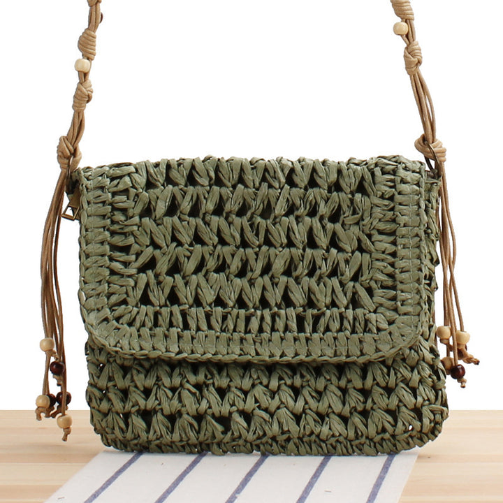 Woven natural material handbag with playful fringes Skanto