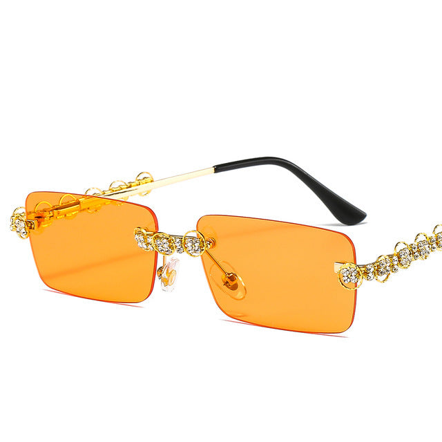 Dame Designer-solbrille med glitrende ramme og rektangulært glass Skanto