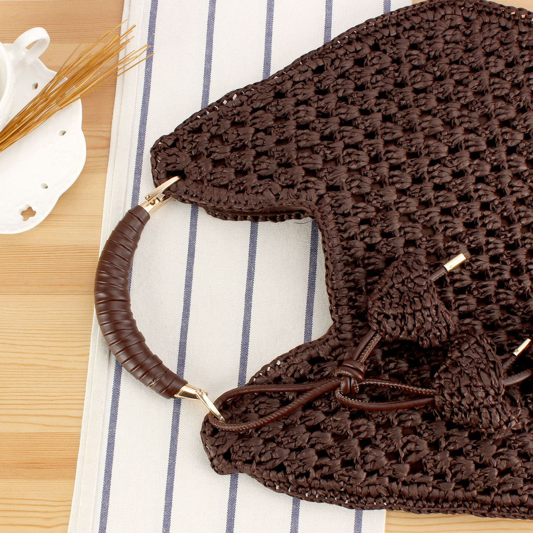 Handbag made of artisanal natural material with unique tassel pendant Skanto