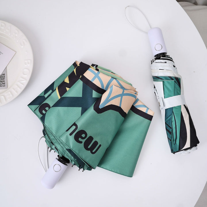 Damer innovativ foldbar paraply med unikt grafisk design Skanto