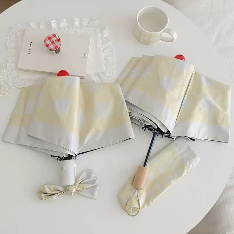 Dame sammenleggbart paraply med spesiell design Skanto