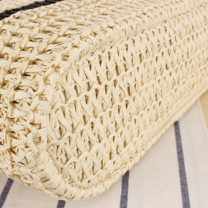 Modern beach bag made of woven natural material with elegant handles Skanto