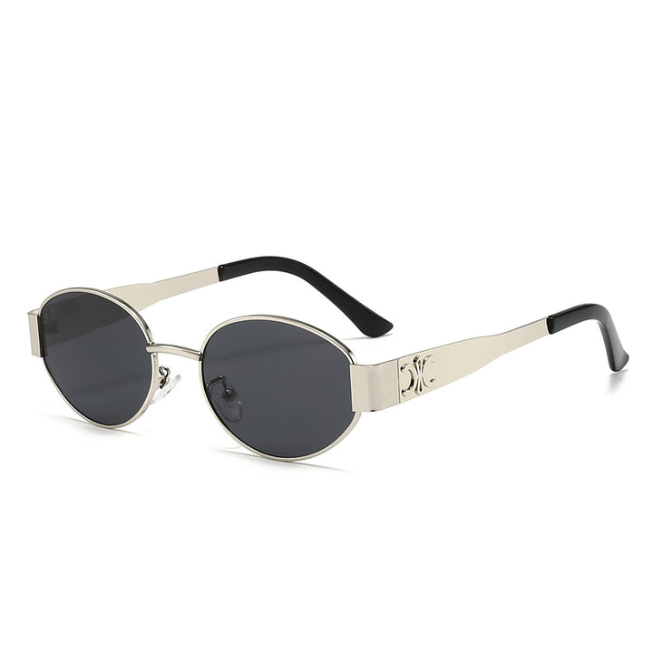 Dame Designer-solbrille med elegant oval ramme og unike aksenter Skanto