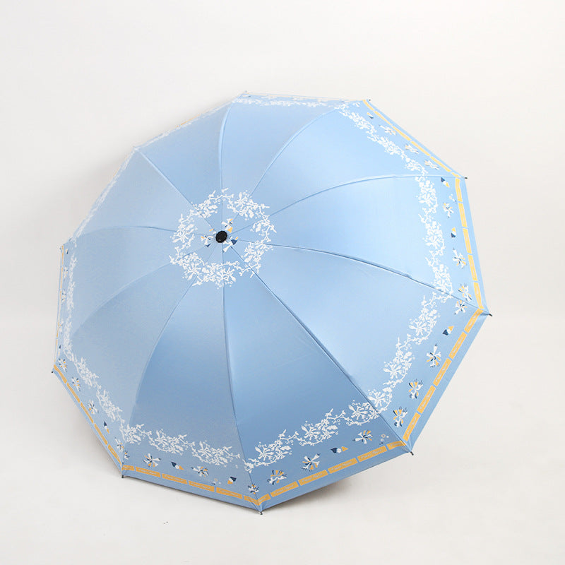Kvinnens elegante sammenleggbare paraply med blomsterdesign Skanto