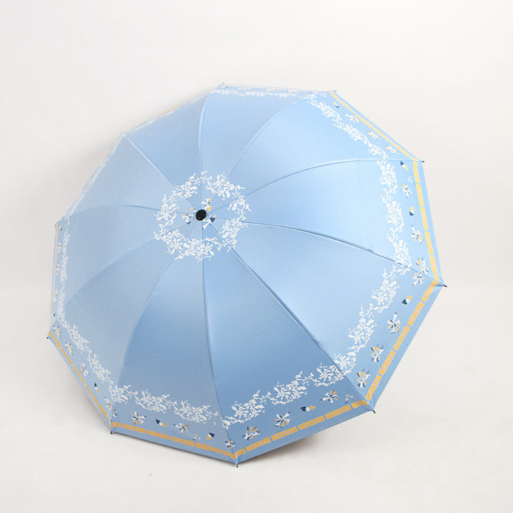 Kvinnens elegante sammenleggbare paraply med blomsterdesign Skanto