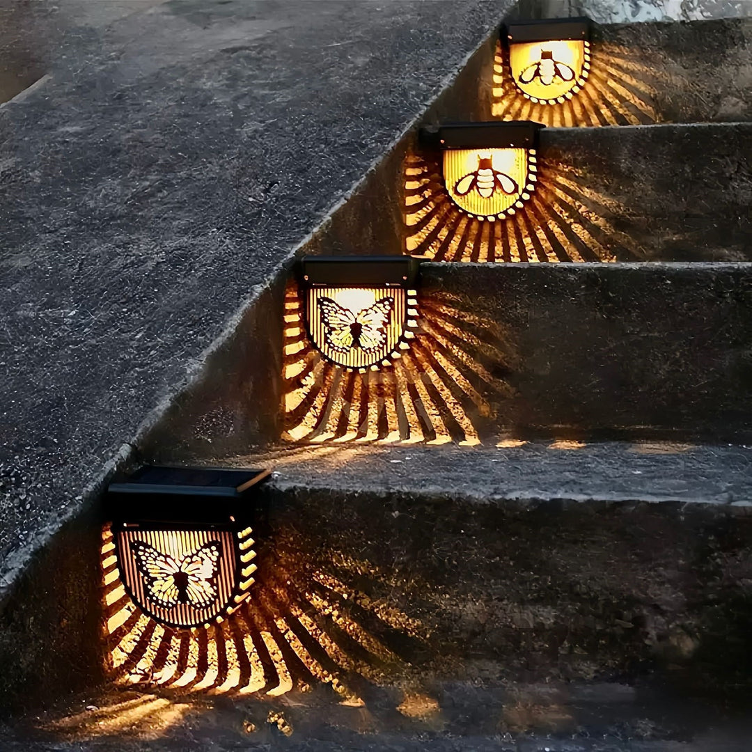 Decorative Solar-Powered Outdoor Wall Lights with Laser-Cut Insect and Flower Panels and Warm LED Ambiance Skanto