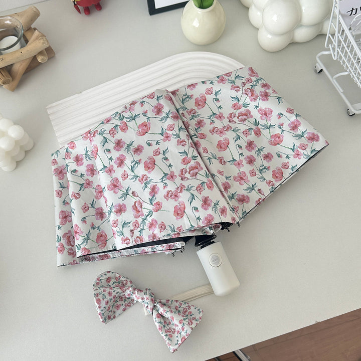 Dame sammenleggbare paraply med blomsterdesign og praktisk oppbevaringssystem Skanto