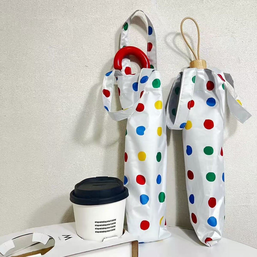 Dame designer Faltregnese med fargerikt prikkemønster Skanto