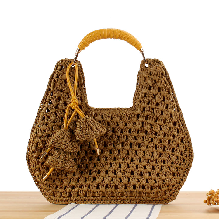 Handbag made of artisanal natural material with unique tassel pendant Skanto