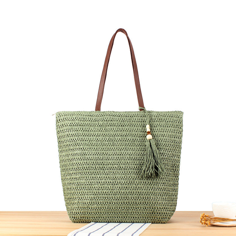 Woven natural material handbag with tassel decoration Skanto