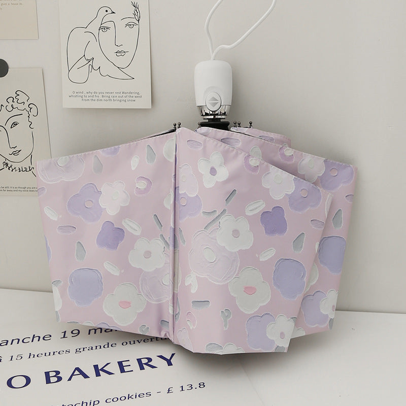 Dame sammenleggbar paraply med stilfullt blomstedesign Skanto