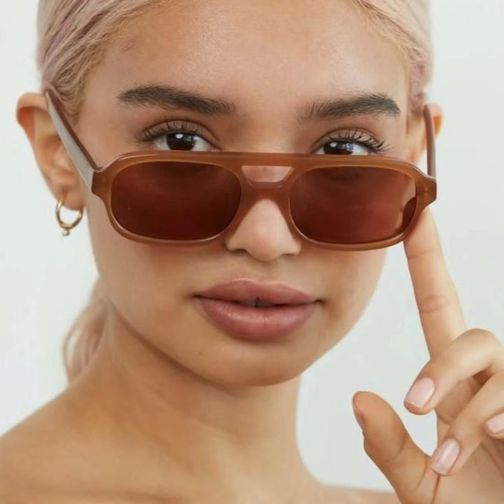Dame moteriktig kvadratisk solbrille laget av transparent plast Skanto