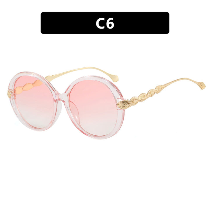 Dame stor rund solbrille med dekorative metalakser Skanto