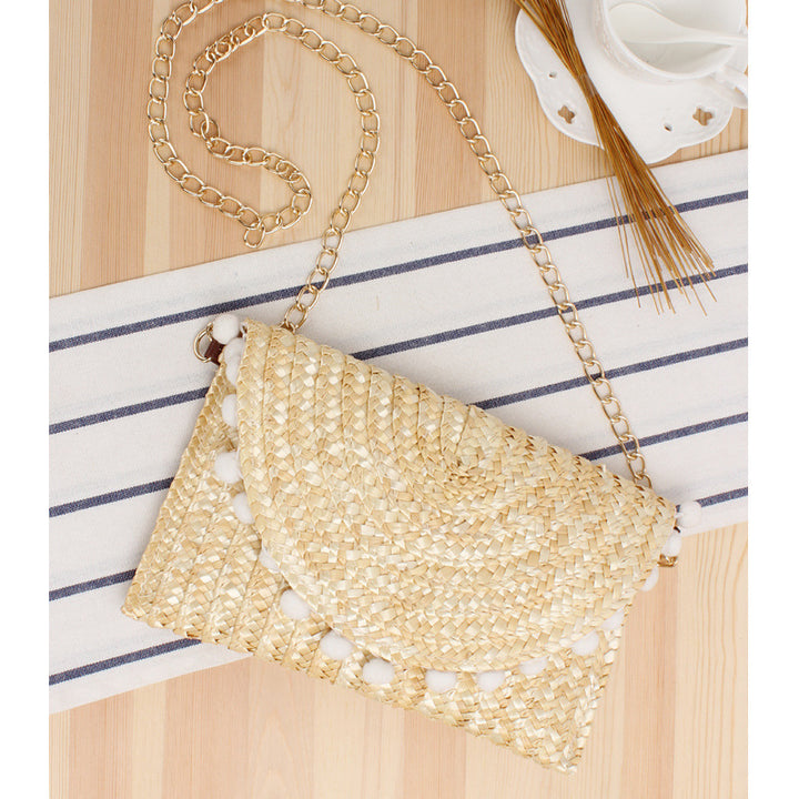 Hand-woven natural material clutch with decorative pom-poms Skanto