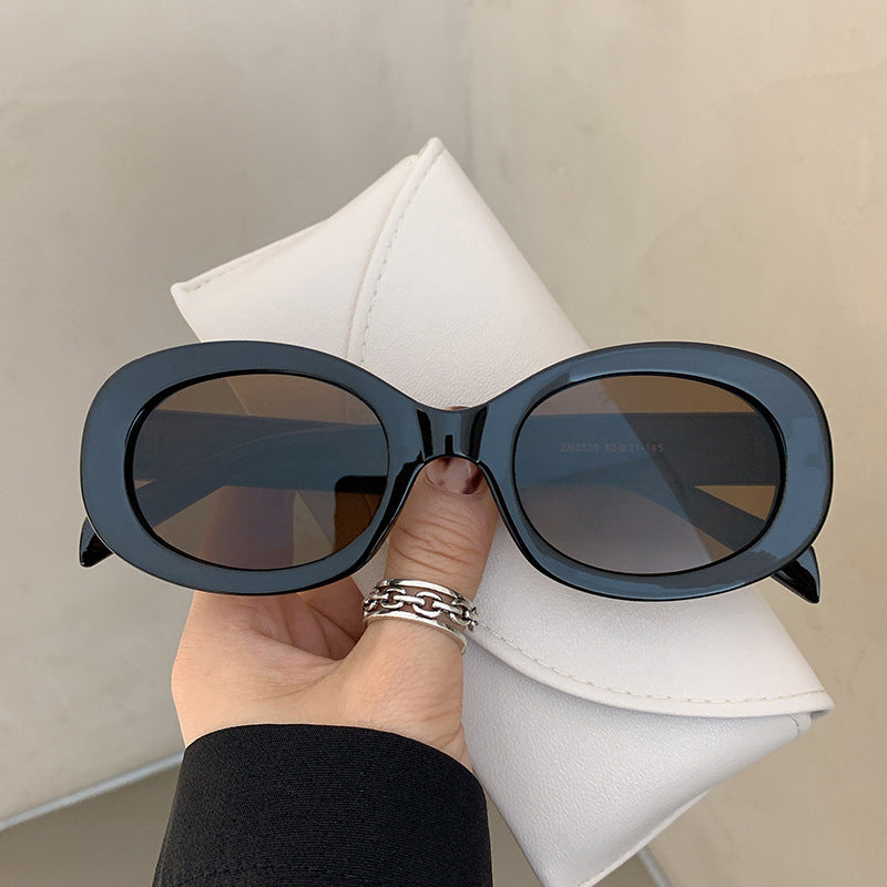 Dame moteriktig solbrille i elegant ovalt design med robust ramme Skanto