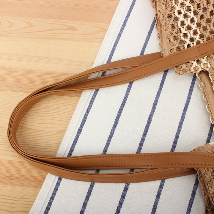 Tote bag made of woven natural material with elegant leather handles Skanto